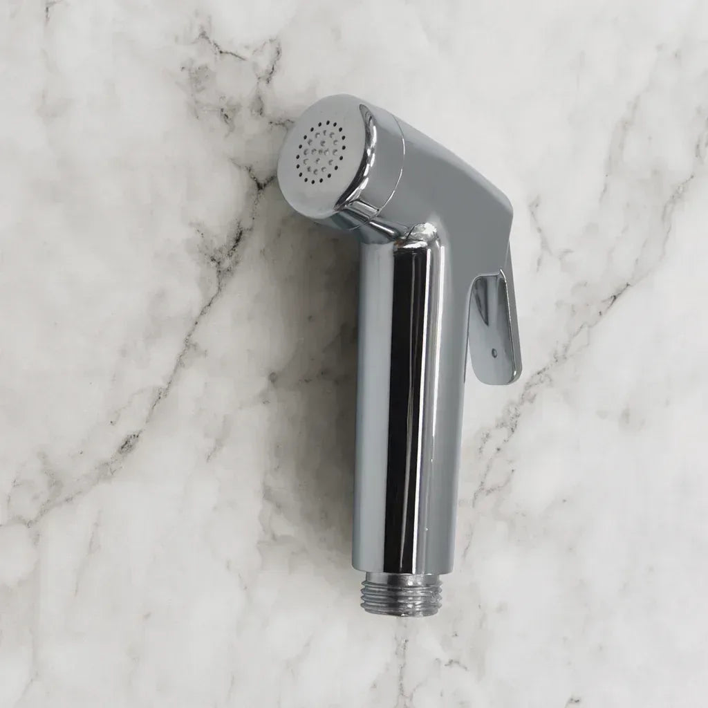 Front view of Real Bidets handheld sprayer on marble background